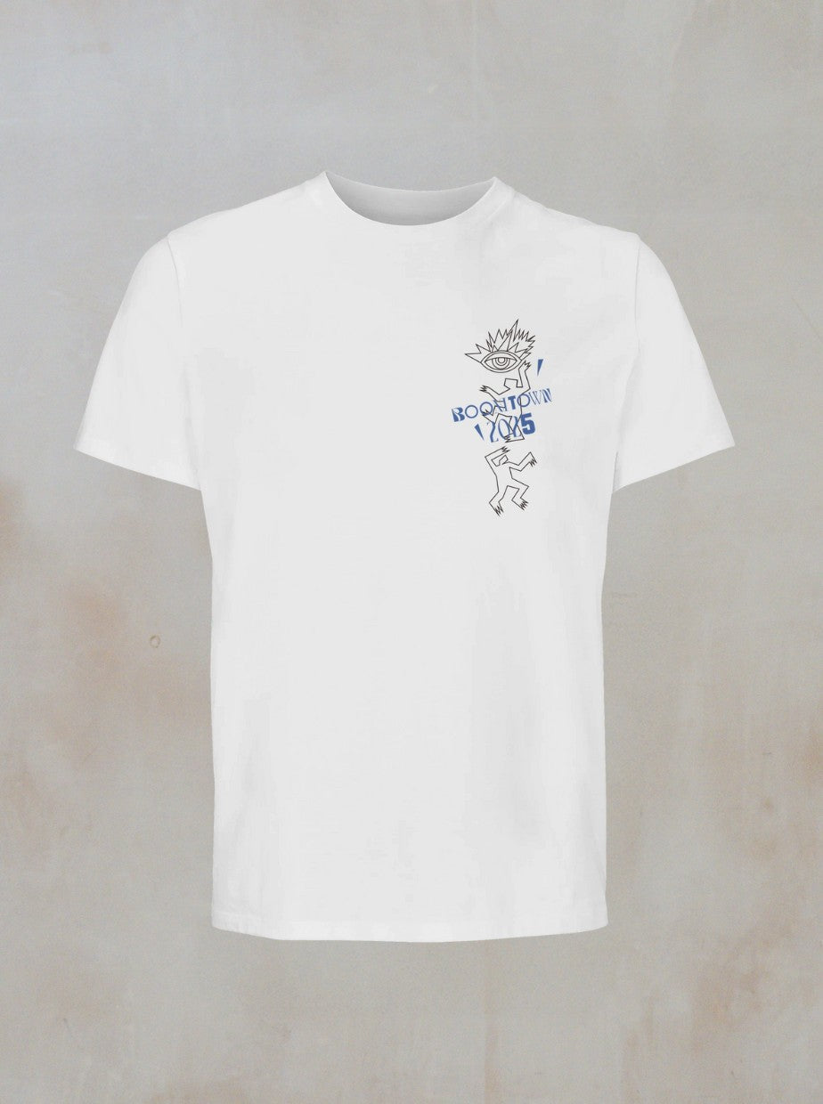 The Motion T-Shirt by Boomtown Fair Shop is an organic cotton tee with a minimalist spiky-haired character and blue ROOFTOP 1985 text on the left chest, set against a neutral backdrop.