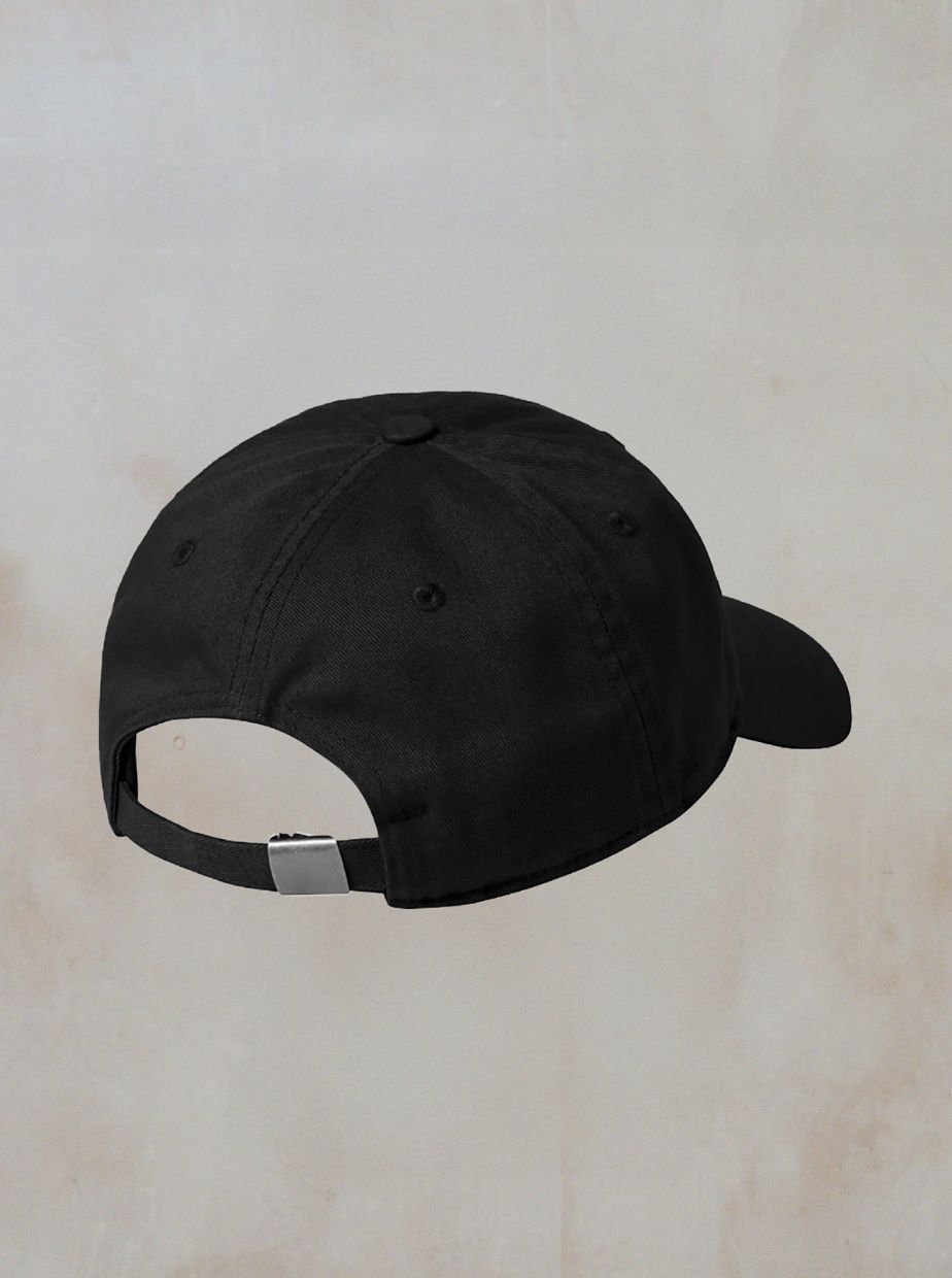 A black Dad Cap from Boomtown Fair Shop is shown from the back with an adjustable strap and silver clasp, set against a neutral light background.