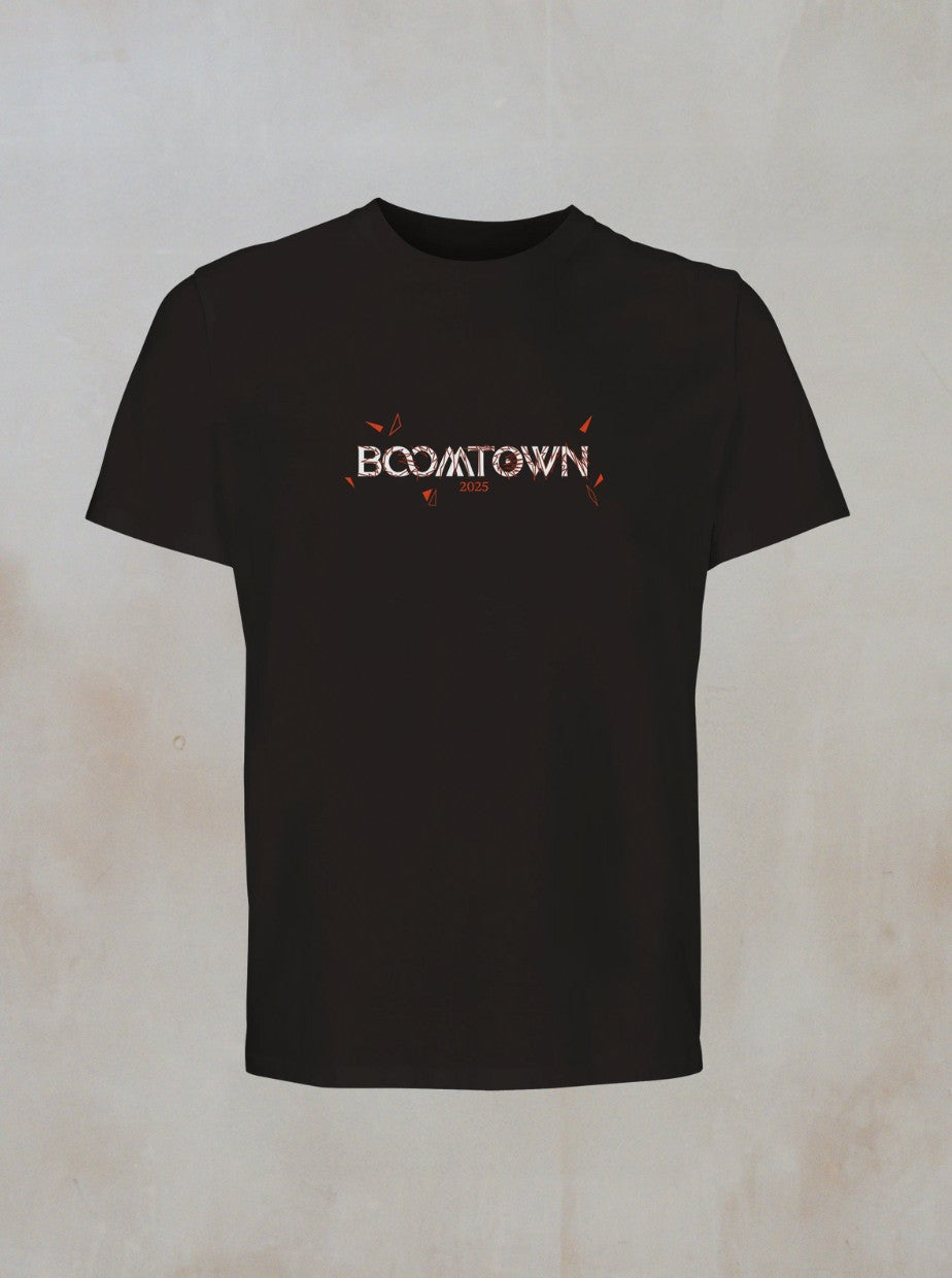 The Mono T-Shirt by Boomtown Fair Shop is a black organic cotton tee with BOOMTOWN in a geometric font featuring orange and white accents on the chest, set against a plain, light background.