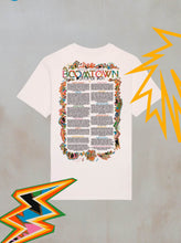 The Boomtown Fair Shops Power of Now: Line Up T-Shirt in organic cotton features colorful abstract borders, multicolored and yellow lightning bolts, and POETIC OF NOW text centered on the back.