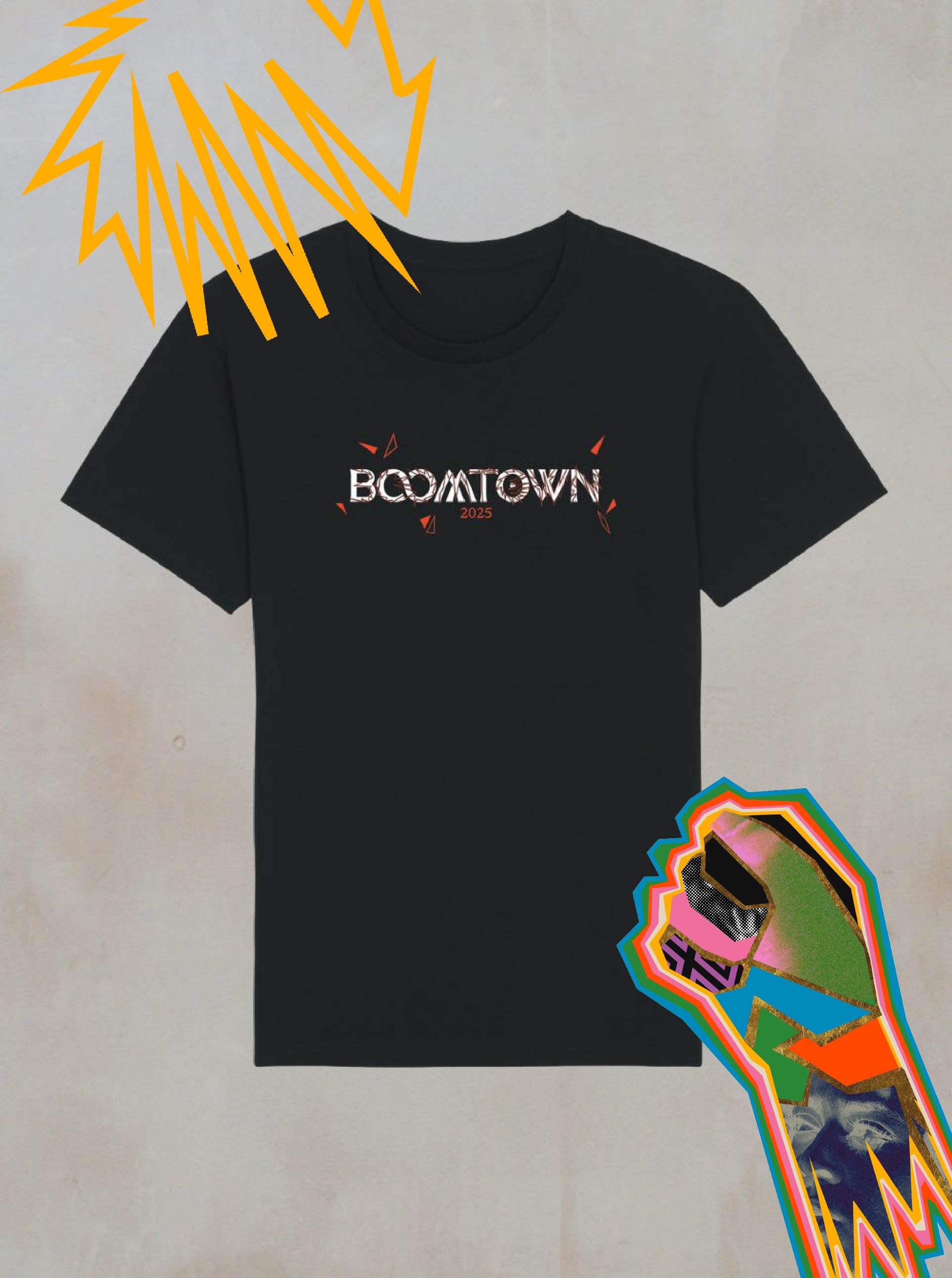 The Power of Now Mono Graphic T-Shirt by Boomtown Fair Shop features bold white BOOMTOWN 2023 text with red accents, a yellow comic burst at the top left, and a colorful geometric fist at the bottom right on a minimalist black background.