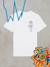 The Power of Now Motion Graphic T-Shirt from Boomtown Fair Shop—a white organic cotton tee with a small black sketch and blue text—hangs on a gray backdrop with blue zigzags, abstract shapes, and food bowls in the corners.