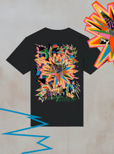 The Boomtown Fair Shops Chapter Four: Power of Now Graphic T-Shirt is a black organic cotton tee with a vibrant multicolored geometric explosion and bold zigzag graphics on the back, inspired by the Power of Now.