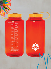 Two Boomtown x Nalgene Power of Now Reusable Water Bottles from the Boomtown Fair Shop, both BPA-free and red with yellow caps, are set against a gray backdrop—one has measurement markings while the other features a white abstract symbol.